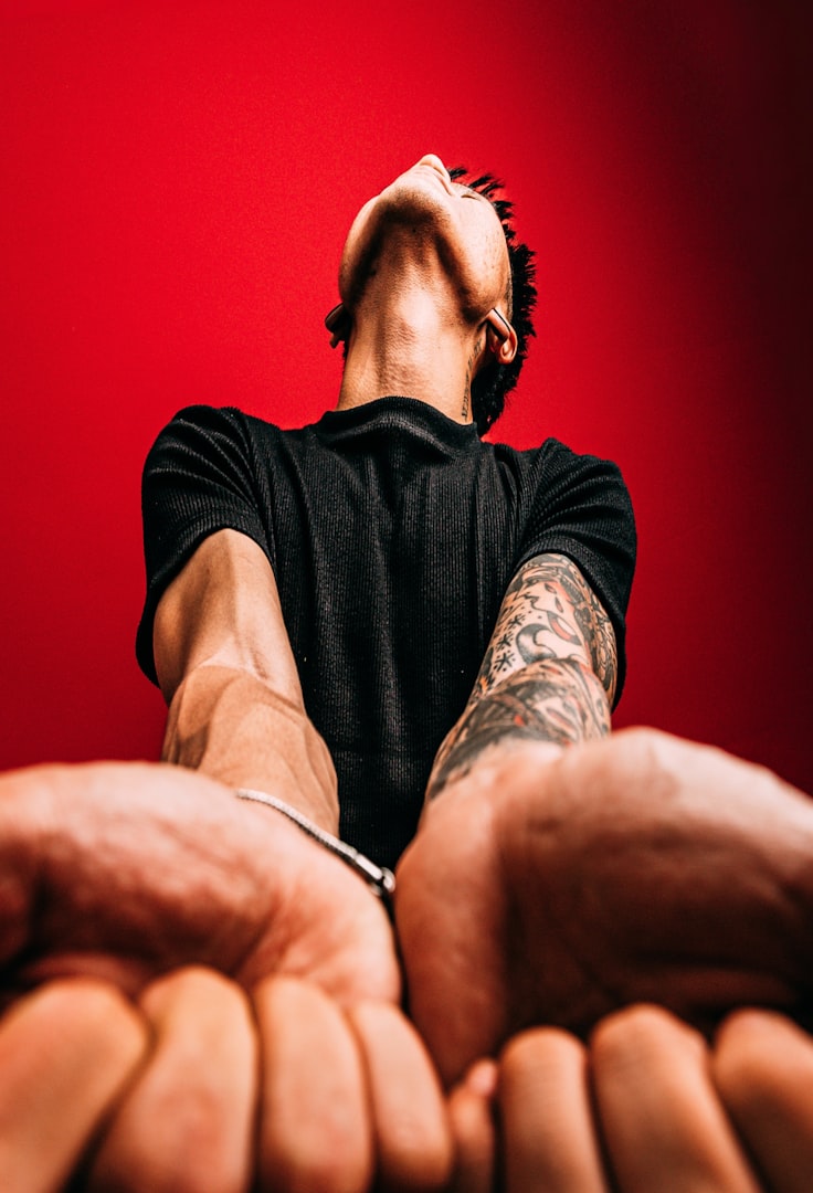 Man with arms outstretched, head tilted back